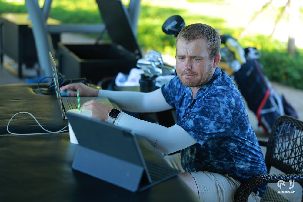 A coach reviewing swing data on a tablet